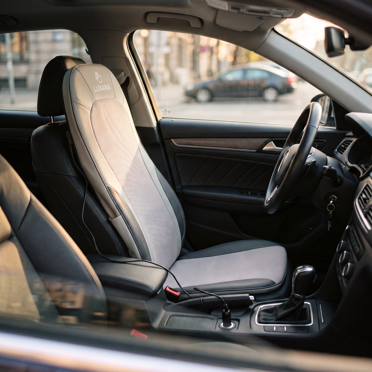 The Sereno Drive on a car driver's seat, plugged into the 12V socket