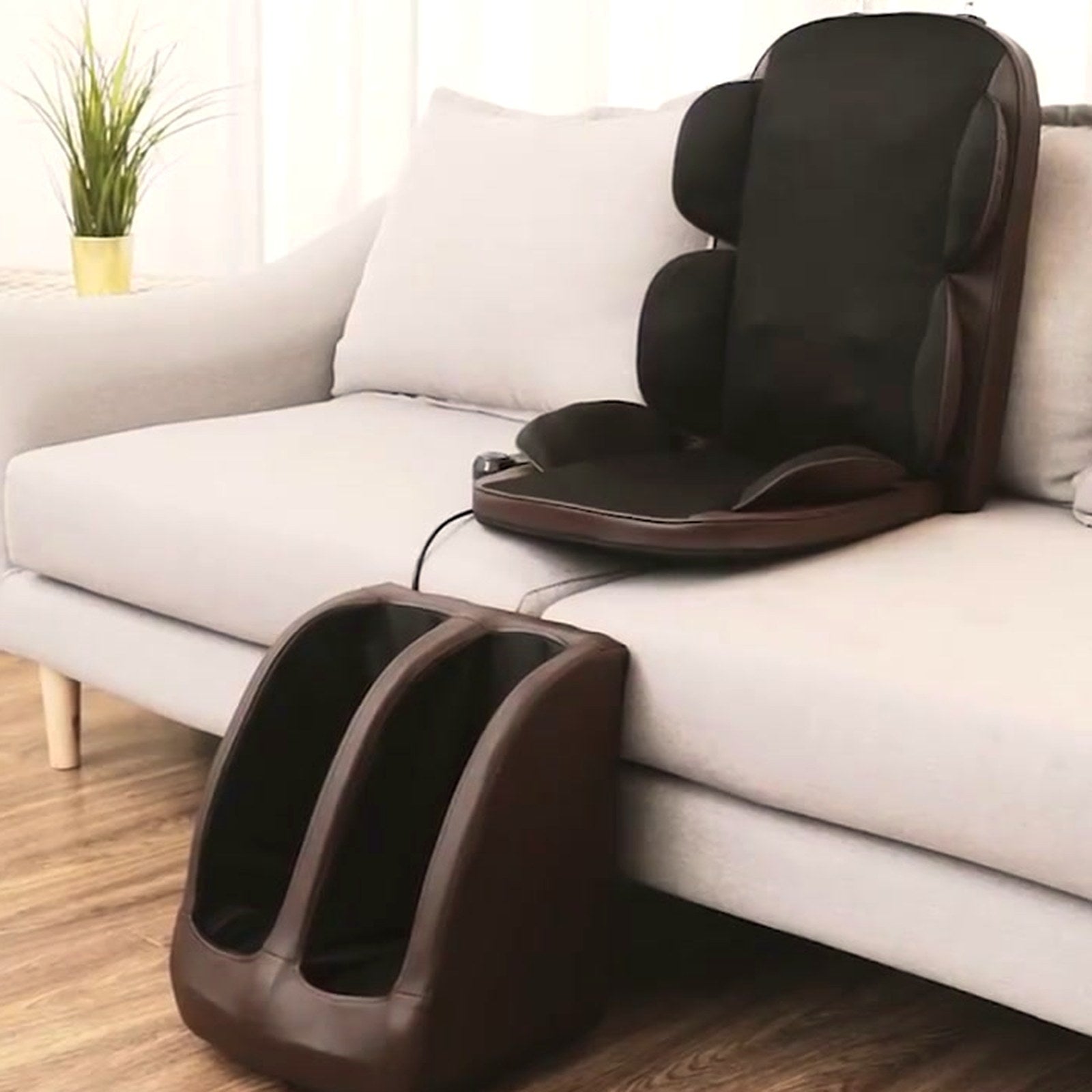 The Grande set up on a light grey sofa with its calf massager below the seat
