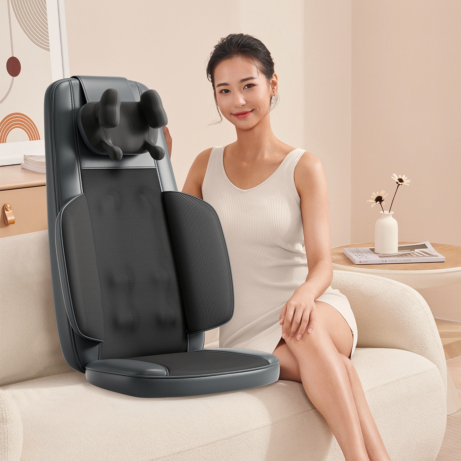 The Notte massage cushion beside a seated woman in a warm cream living room