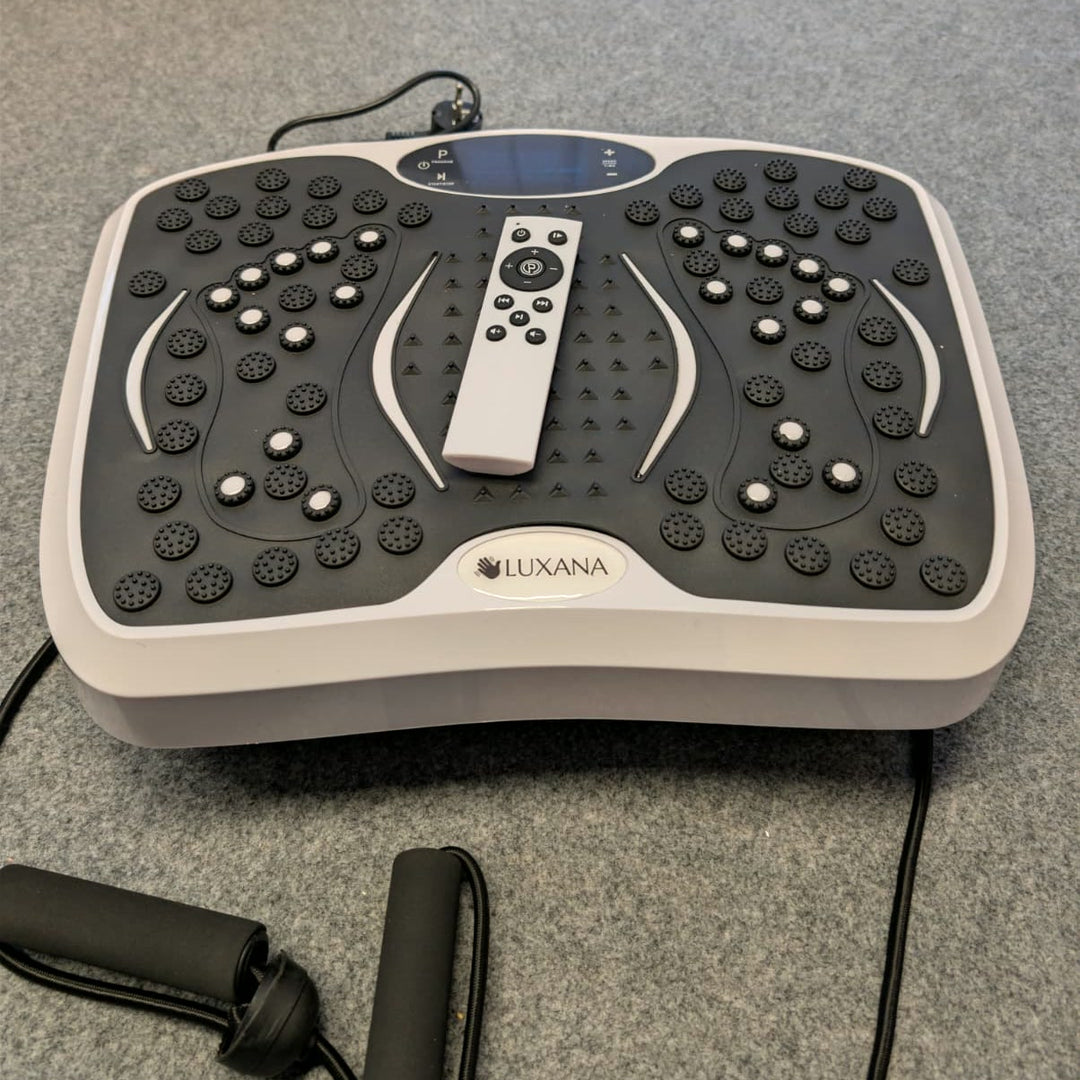 The Vibra vibration plate with its remote control and two arm resistance bands